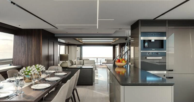 a large kitchen with a dining table aboard WORTH THE WAIT Yacht for Sale