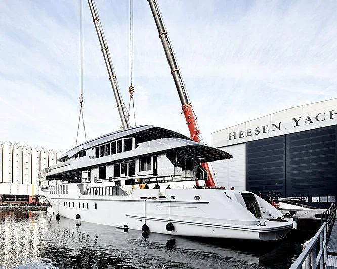 a white boat in a harbor aboard JUNO Yacht for Sale