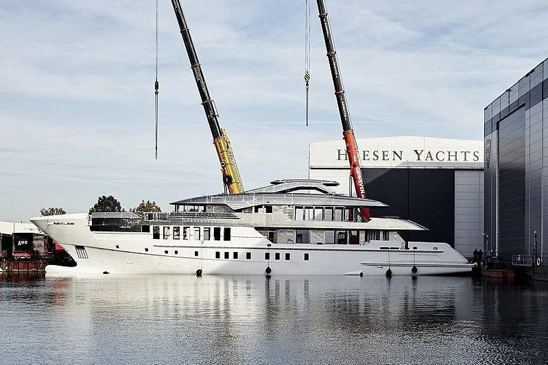 a large white boat in a harbor aboard JUNO Yacht for Sale