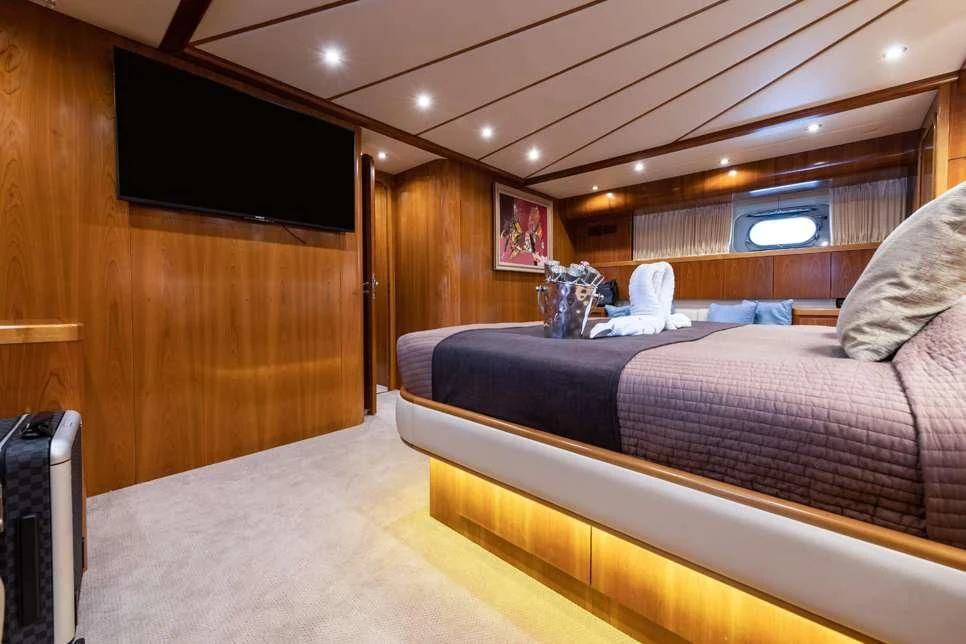a room with a bed and a television aboard STAR LINK Yacht for Sale