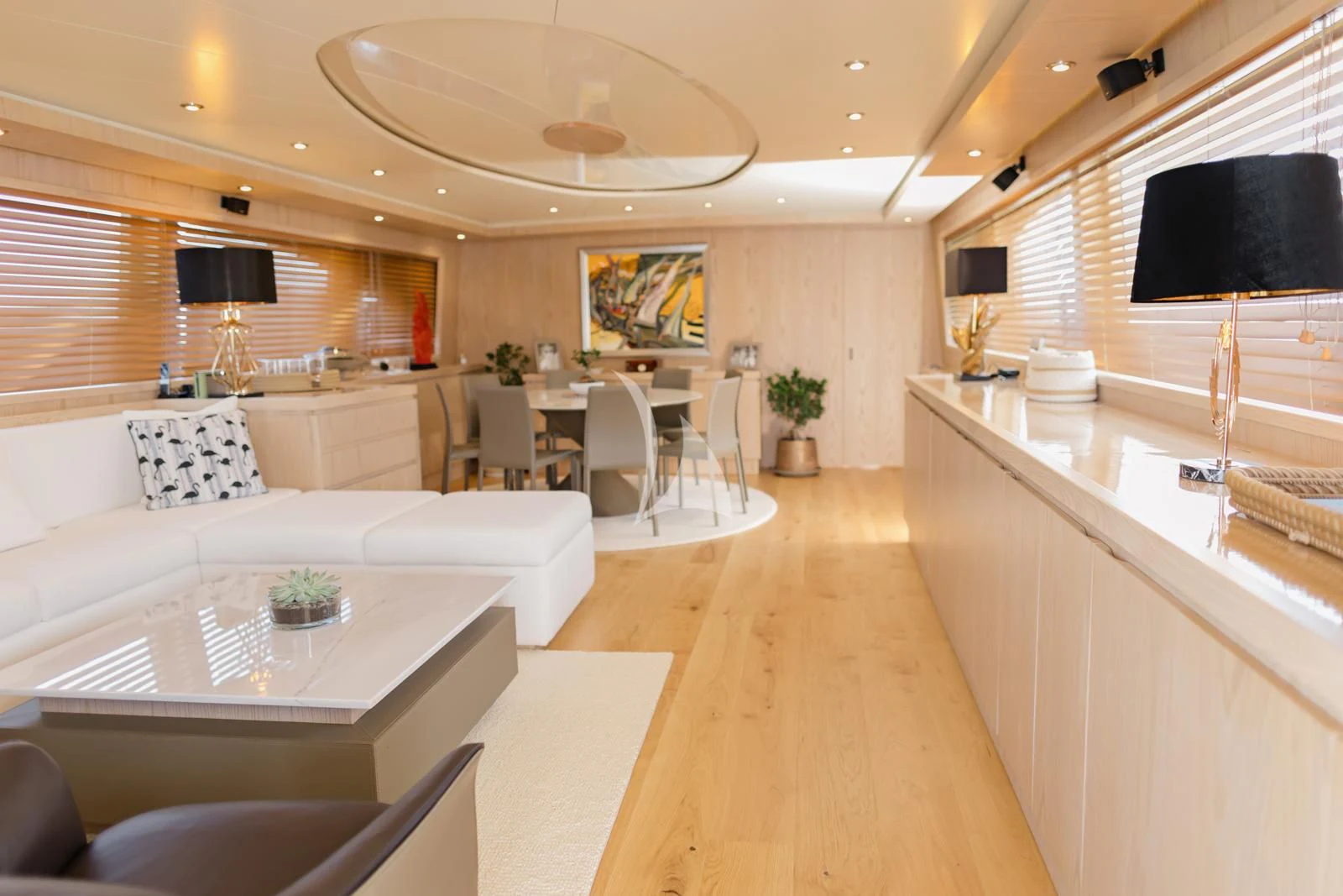 a large living room with a kitchen and dining area aboard STAR LINK Yacht for Sale