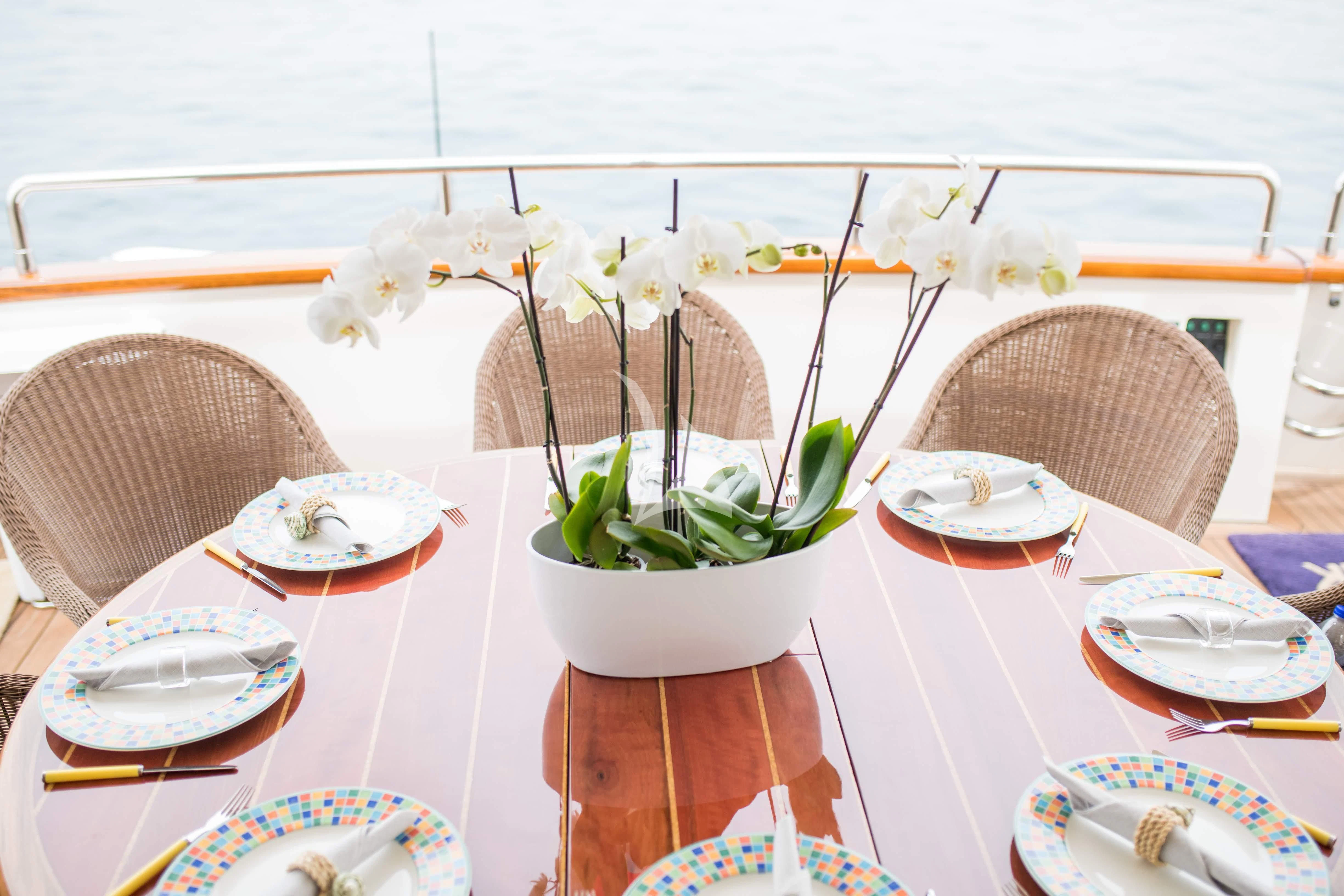 a table with plates and plates aboard STAR LINK Yacht for Sale