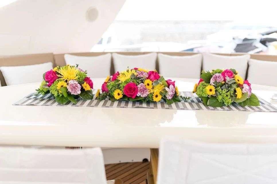 a table with flowers and chairs aboard STAR LINK Yacht for Sale
