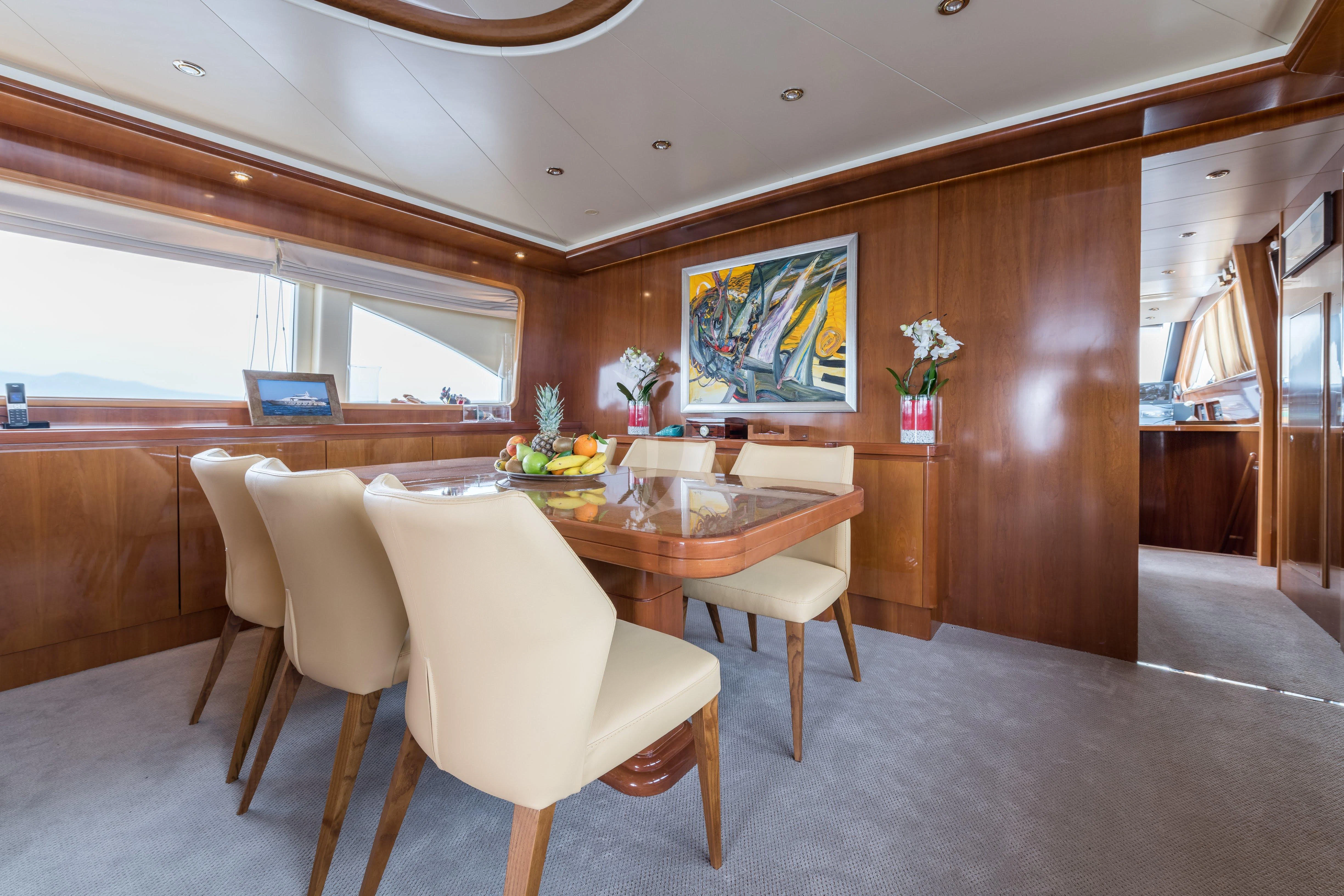 a room with a table and chairs aboard STAR LINK Yacht for Sale