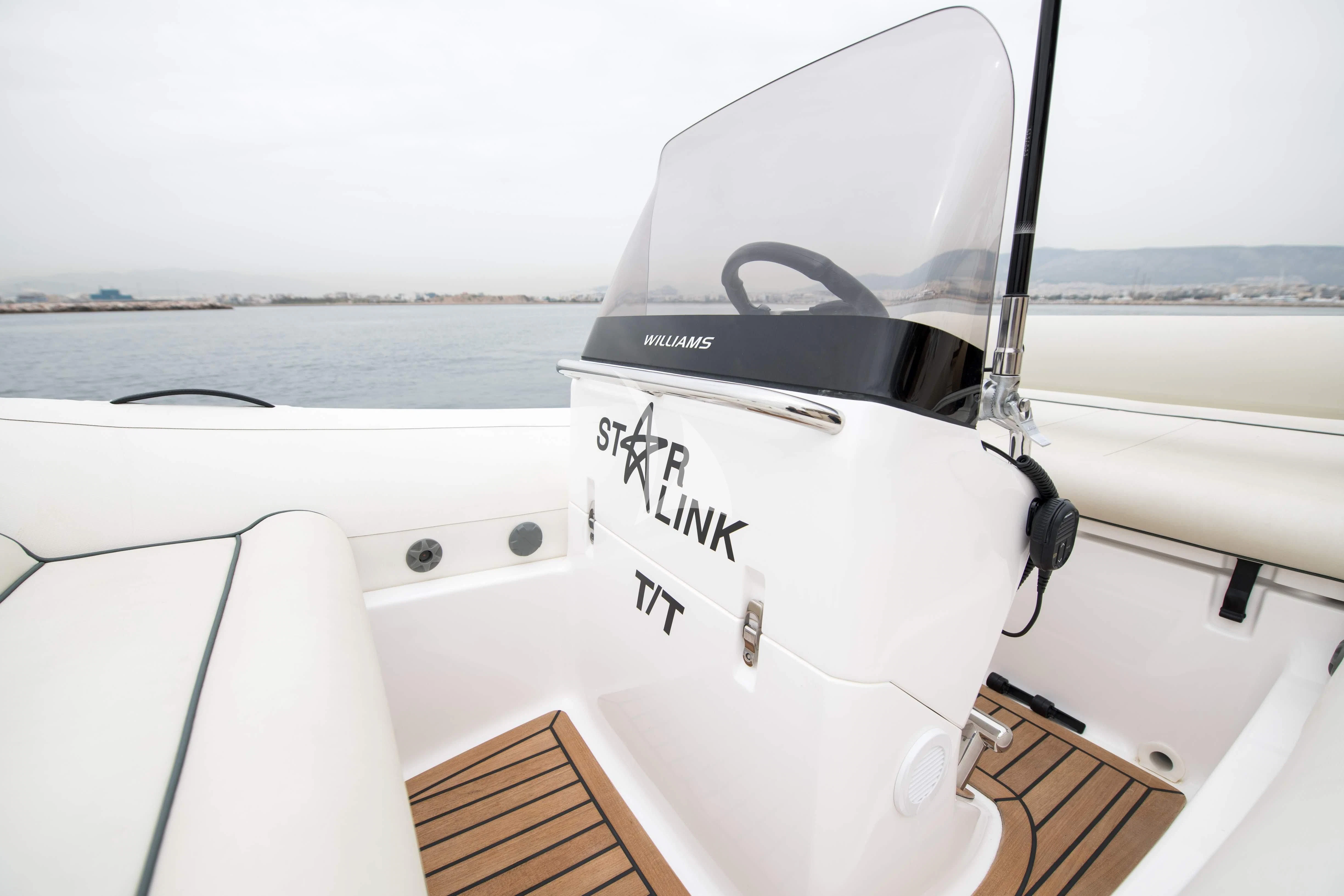 a white boat with black text on it aboard STAR LINK Yacht for Sale
