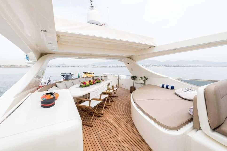 a room with a bed and a table with chairs aboard STAR LINK Yacht for Sale
