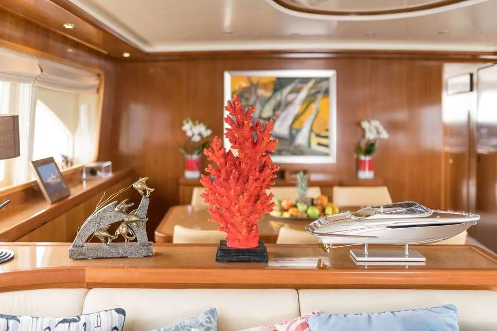 a vase with red flowers on a table aboard STAR LINK Yacht for Sale