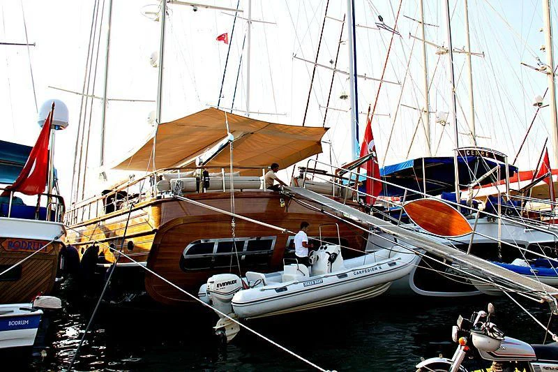 a boat docked with a boat aboard LA BELLA VITA Yacht for Sale