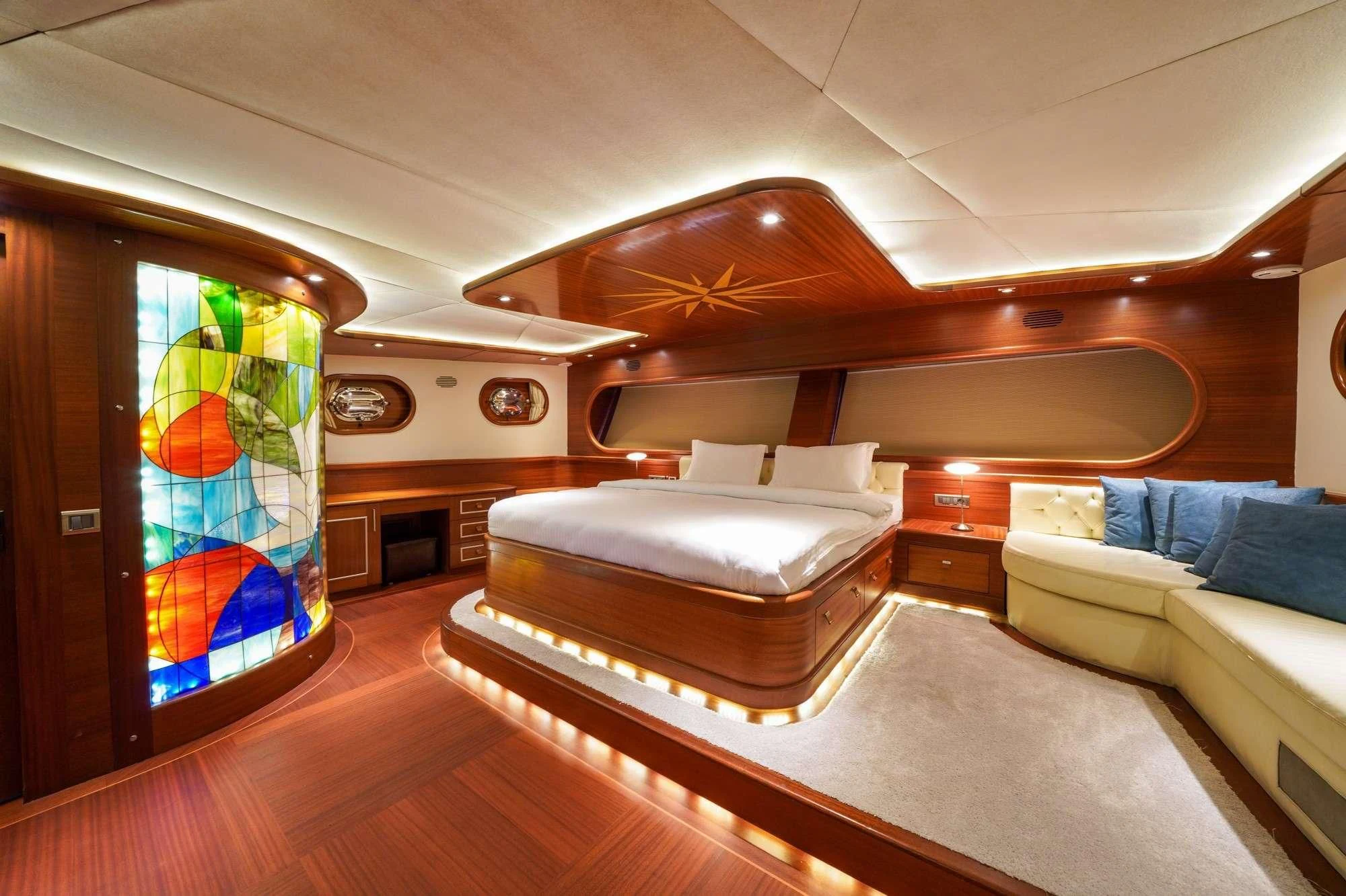 a room with a couch and a tv in it aboard LA BELLA VITA Yacht for Sale