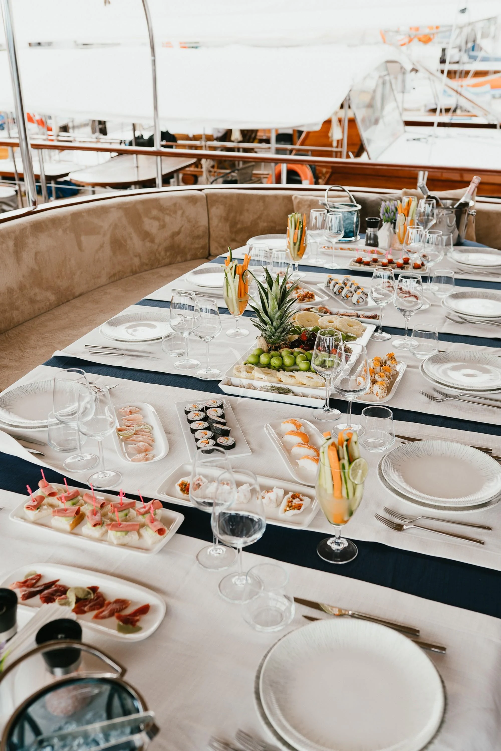 a table with plates and glasses aboard LA BELLA VITA Yacht for Sale
