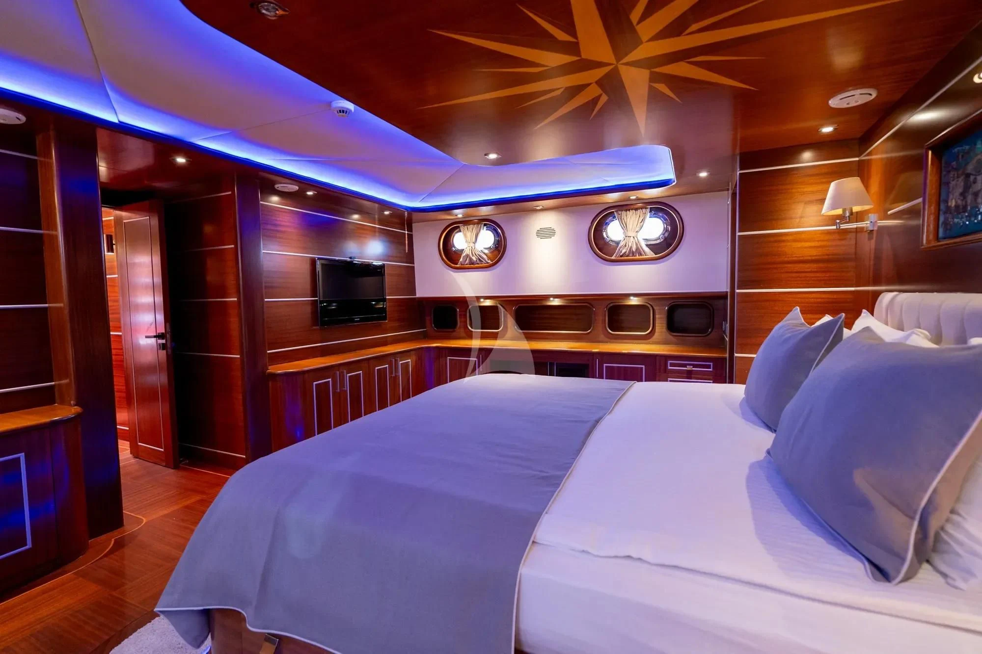 a room with a bed and a television aboard LA BELLA VITA Yacht for Sale