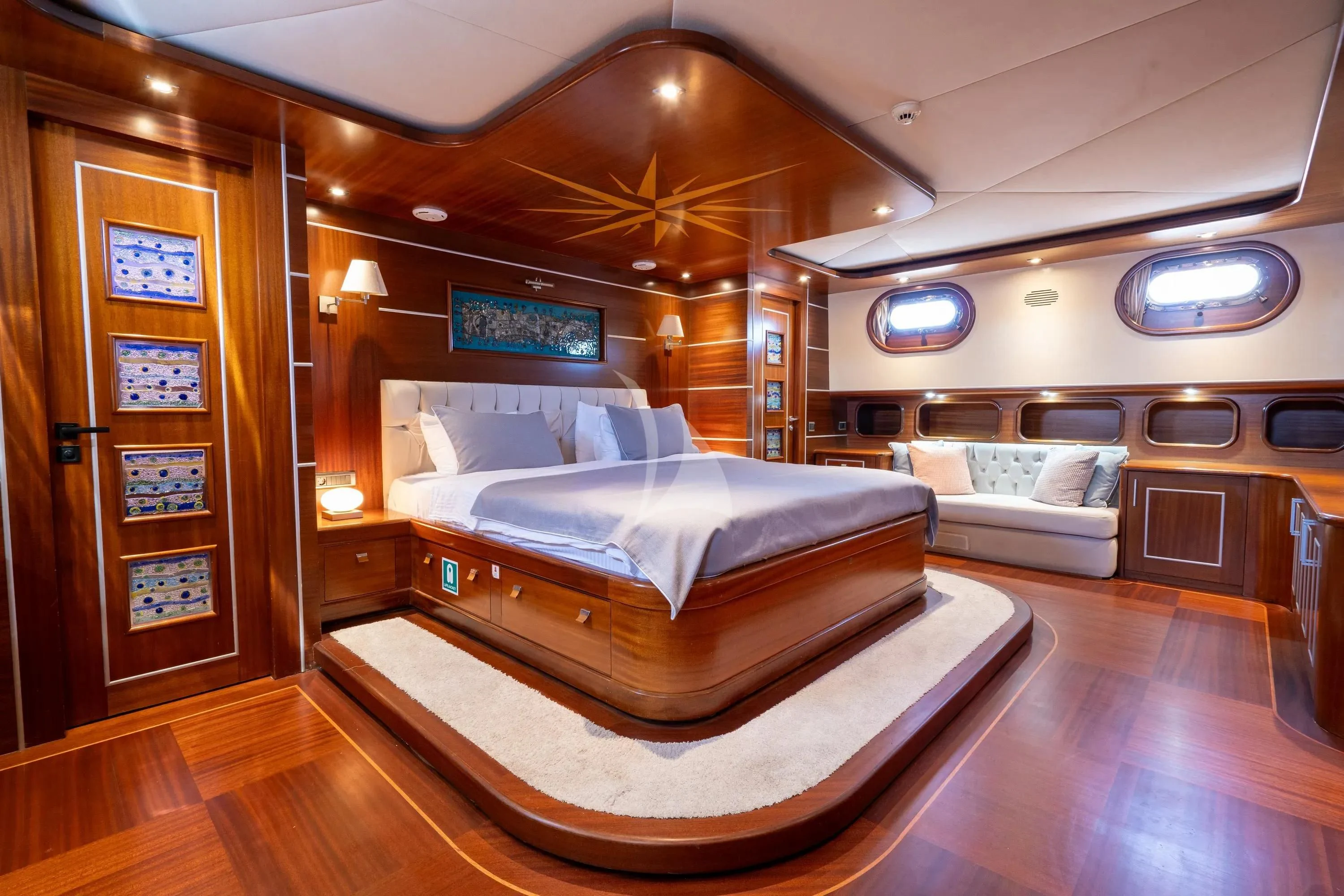 a room with a bed and a couch aboard LA BELLA VITA Yacht for Sale