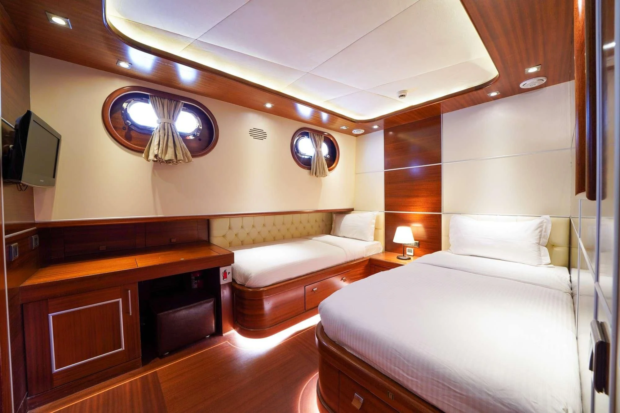 a room with a bed and a desk aboard LA BELLA VITA Yacht for Sale