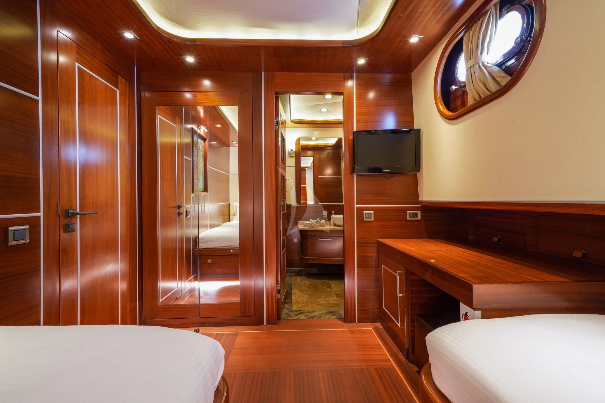 a room with a bed and a desk aboard LA BELLA VITA Yacht for Sale