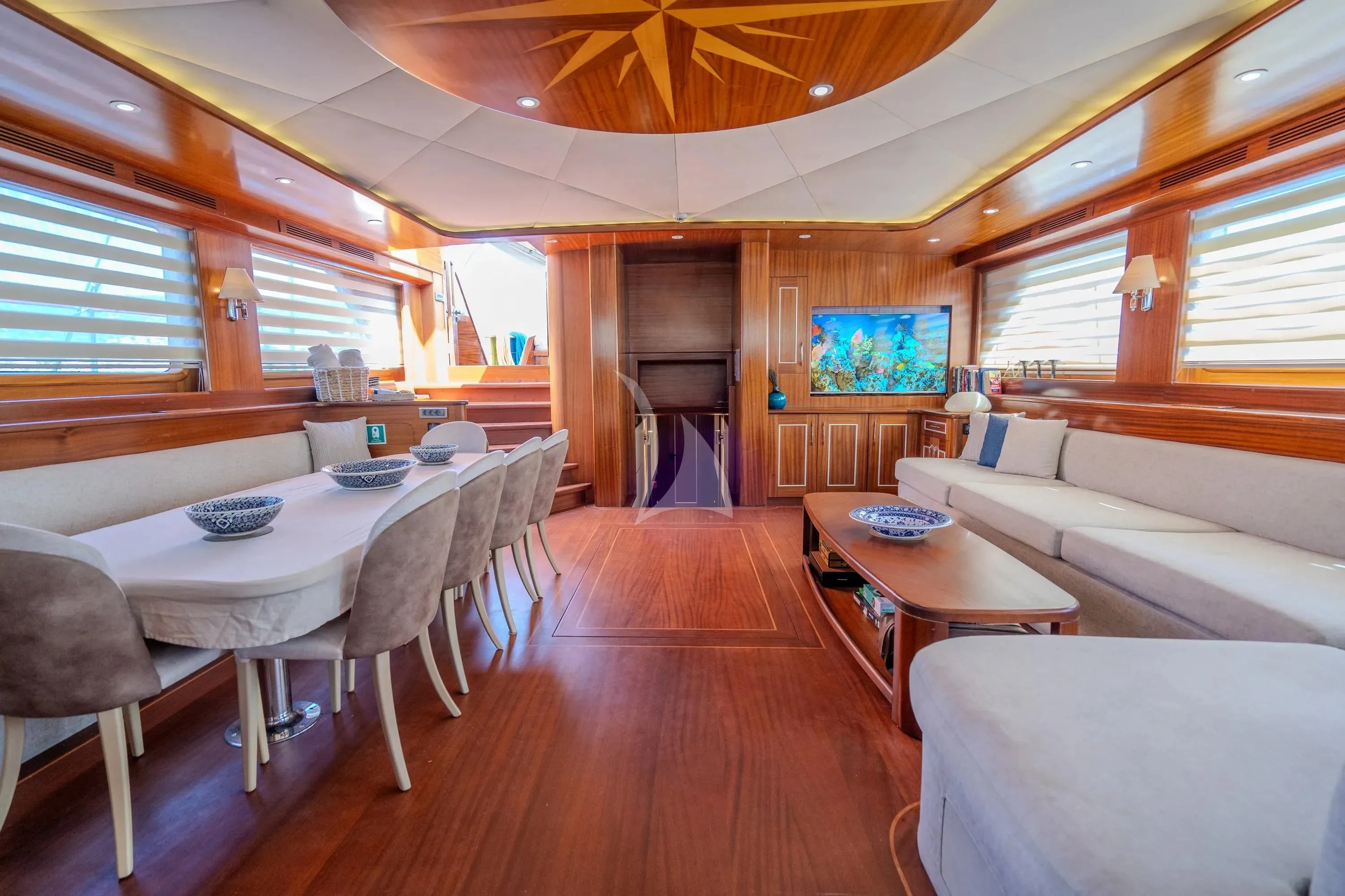 a room with a table and couch aboard LA BELLA VITA Yacht for Sale
