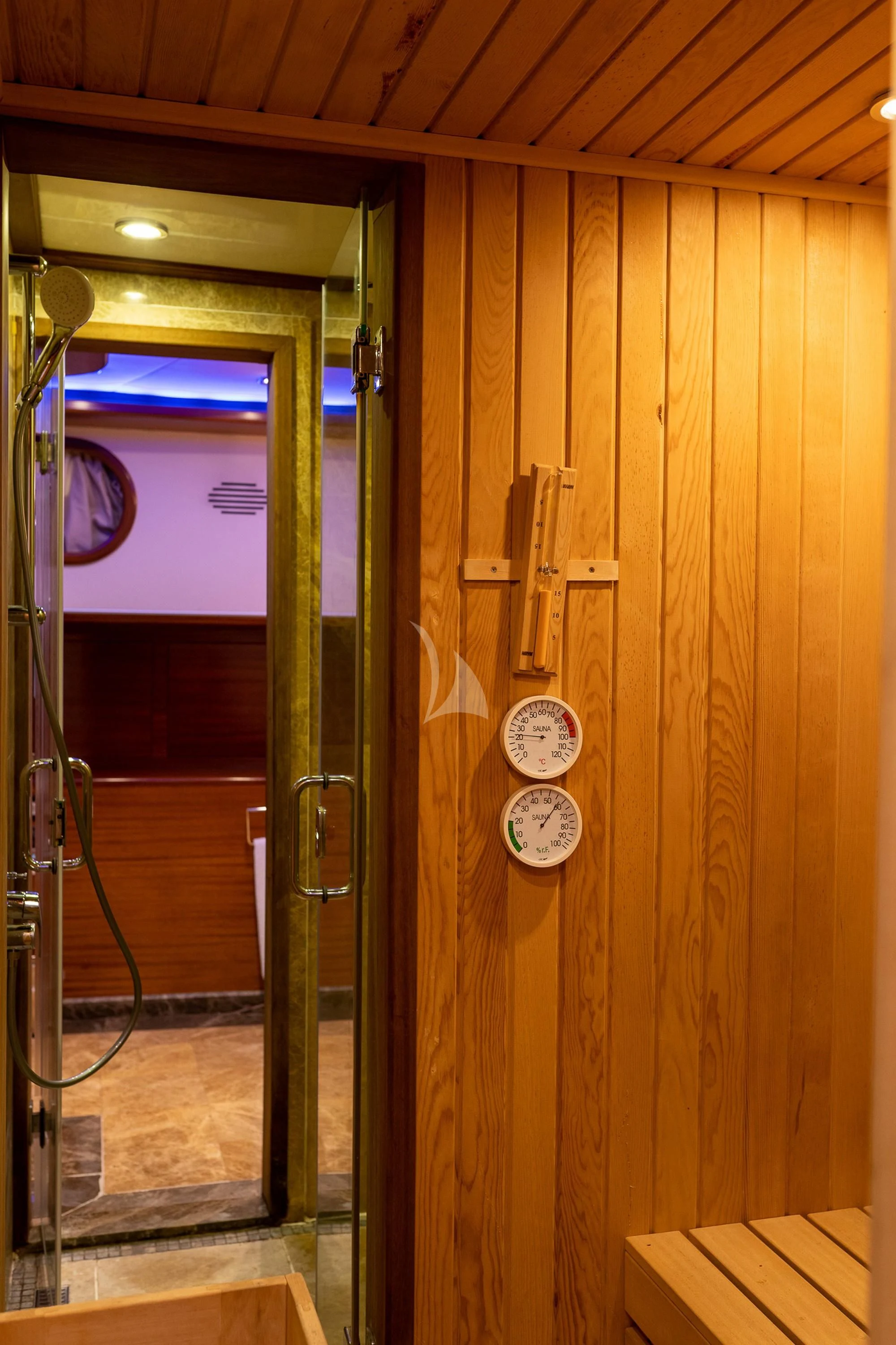 a room with a mirror and a wall with a clock on it aboard LA BELLA VITA Yacht for Sale