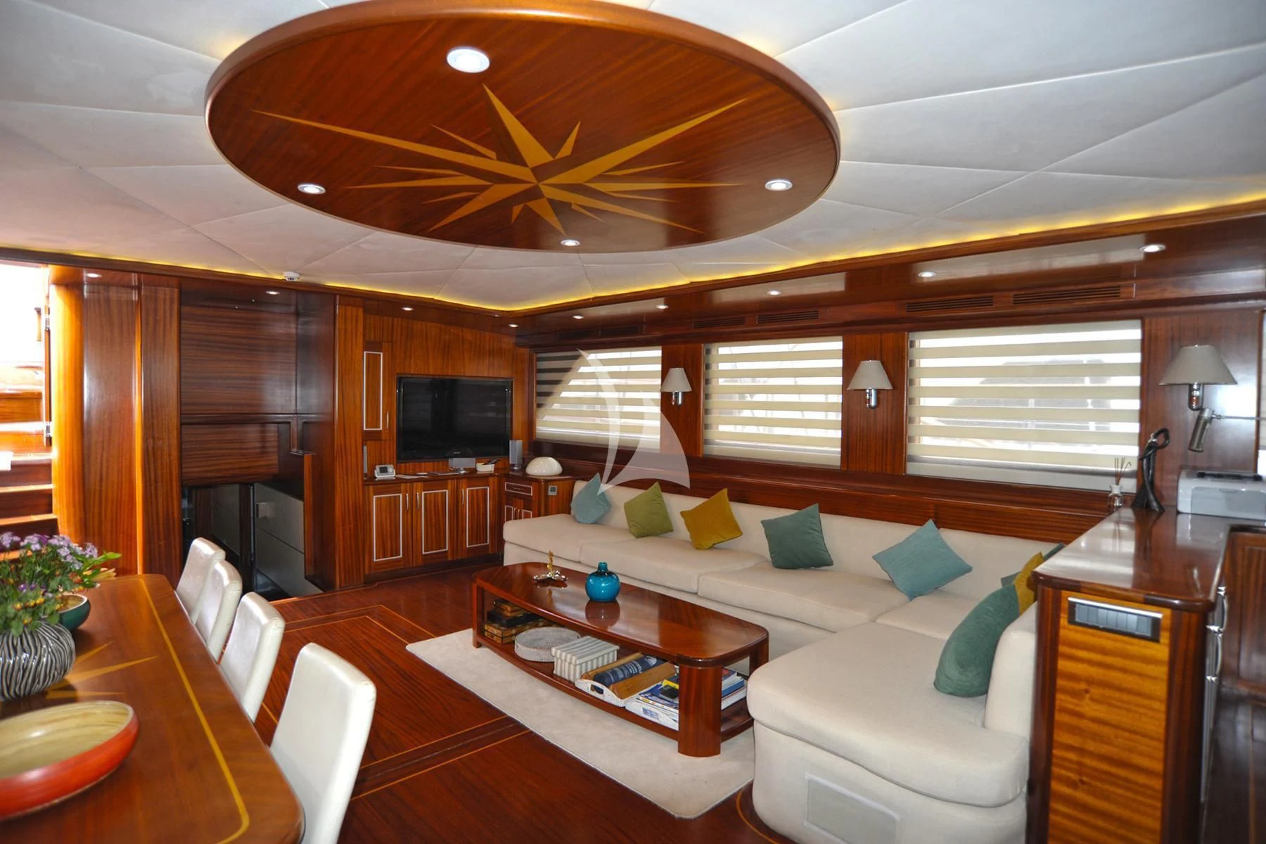 a living room with a couch and a table aboard LA BELLA VITA Yacht for Sale
