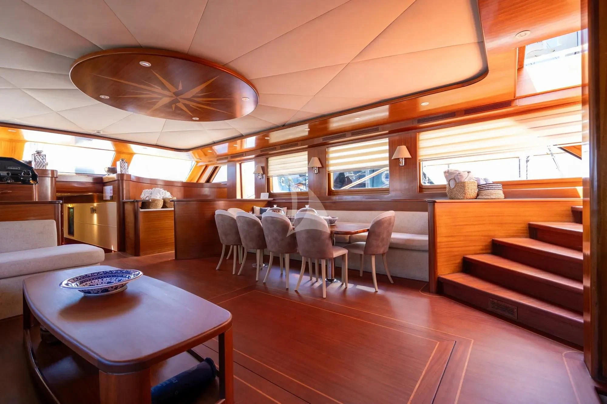 a room with tables and chairs aboard LA BELLA VITA Yacht for Sale