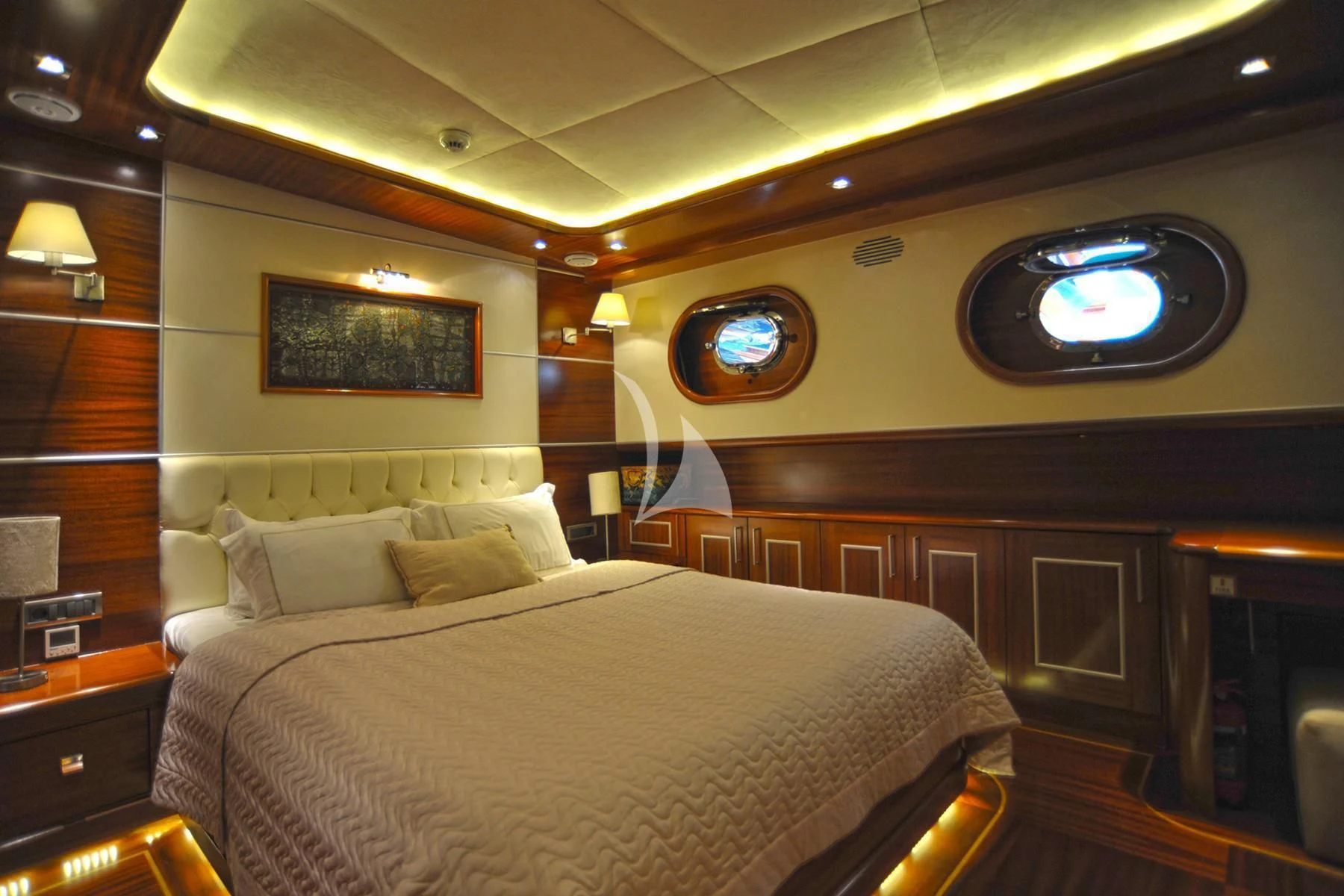 a bedroom with a bed and a large round clock aboard LA BELLA VITA Yacht for Sale