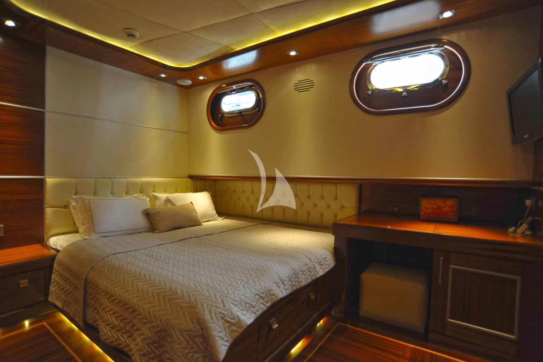a room with a bed and a desk aboard LA BELLA VITA Yacht for Sale