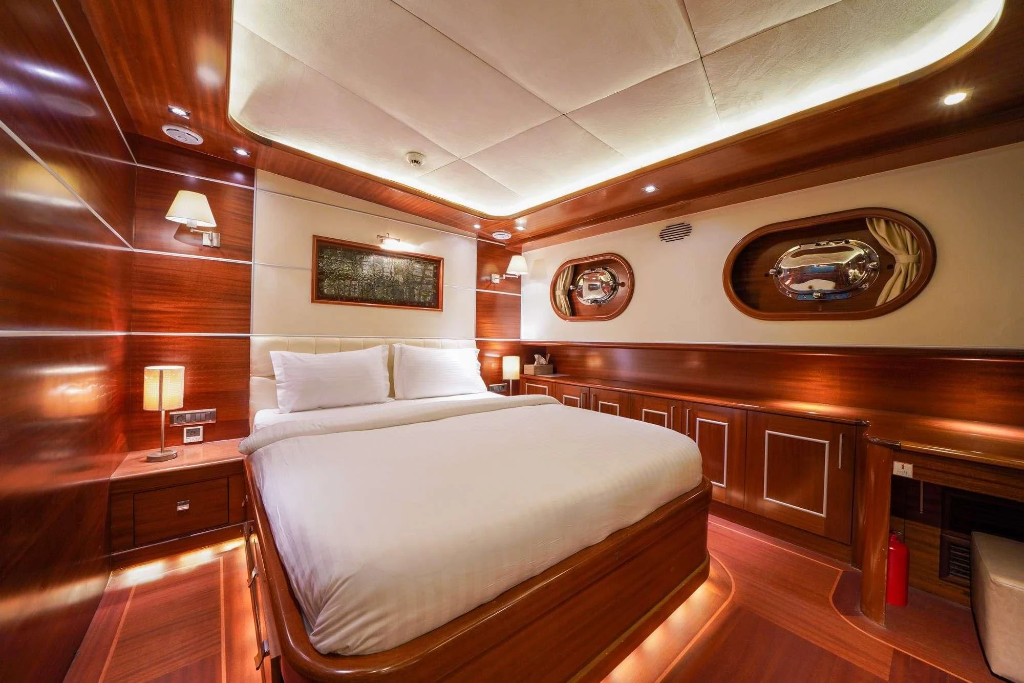 a room with a bed and a wood wall aboard LA BELLA VITA Yacht for Sale