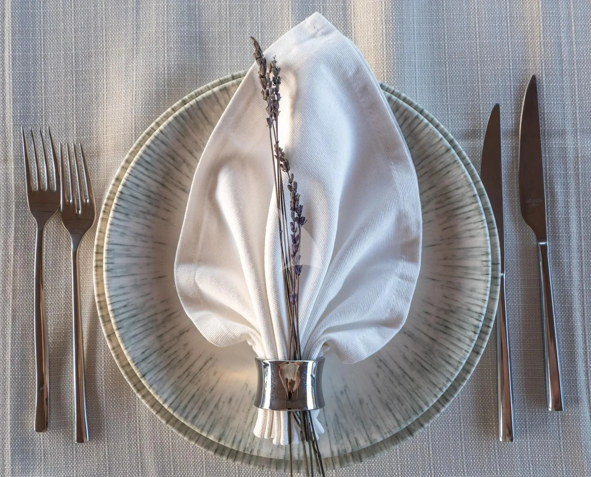 a plate with silverware and silverware on it aboard LA BELLA VITA Yacht for Sale