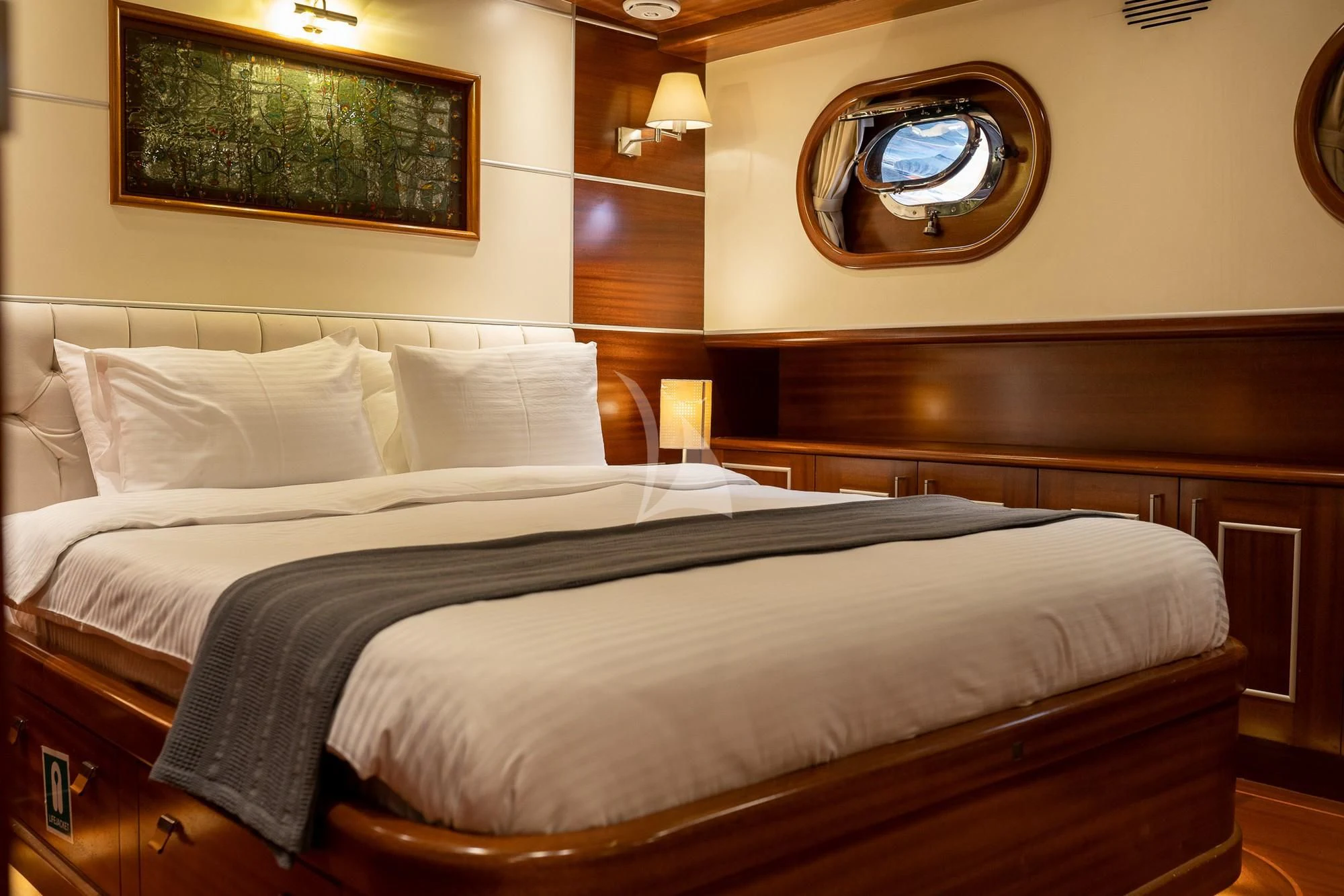 a bed with a large headboard aboard LA BELLA VITA Yacht for Sale