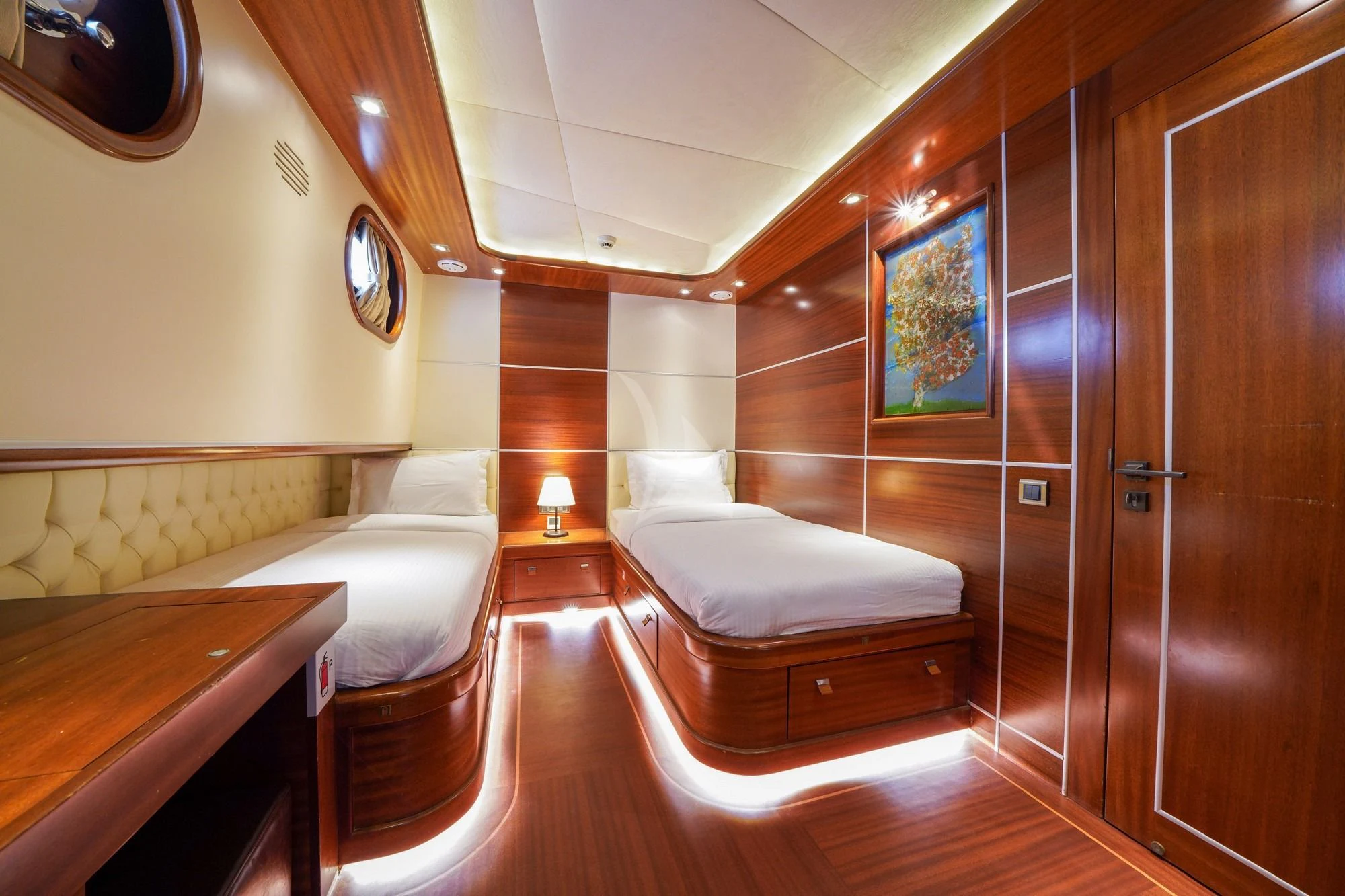 a room with a bed and a mirror aboard LA BELLA VITA Yacht for Sale