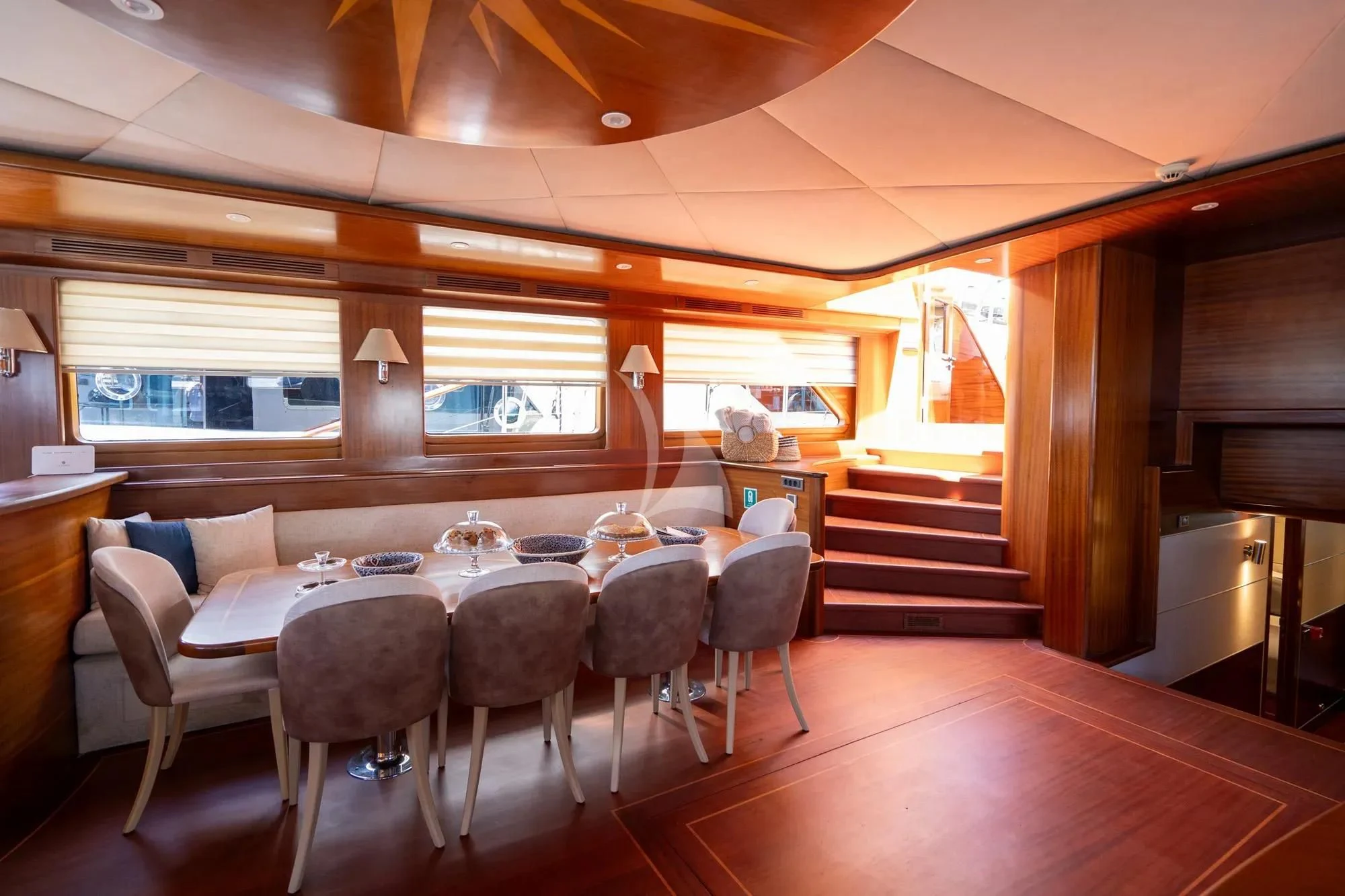 a room with tables and chairs aboard LA BELLA VITA Yacht for Sale