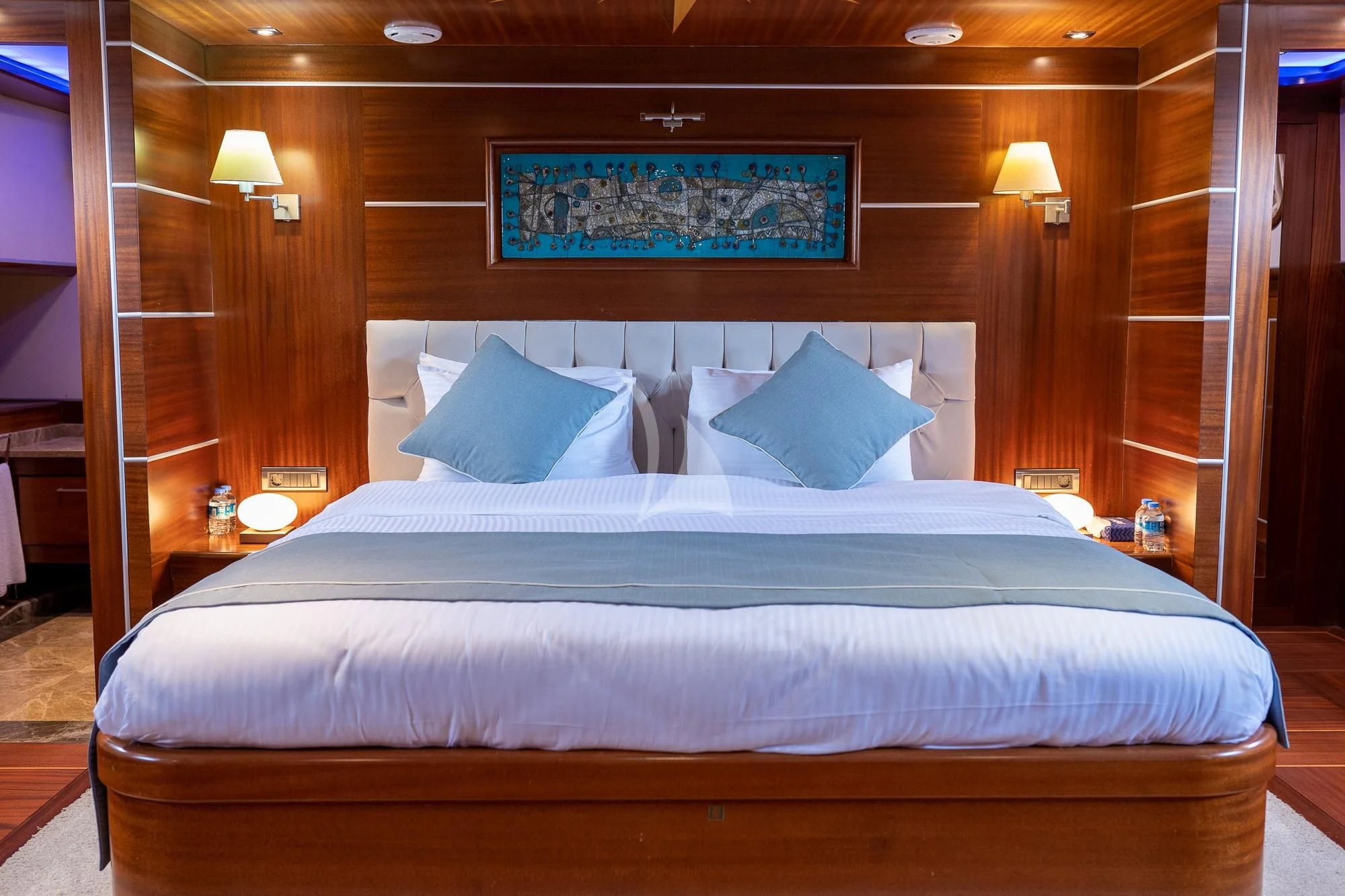 a bed with a white comforter aboard LA BELLA VITA Yacht for Sale
