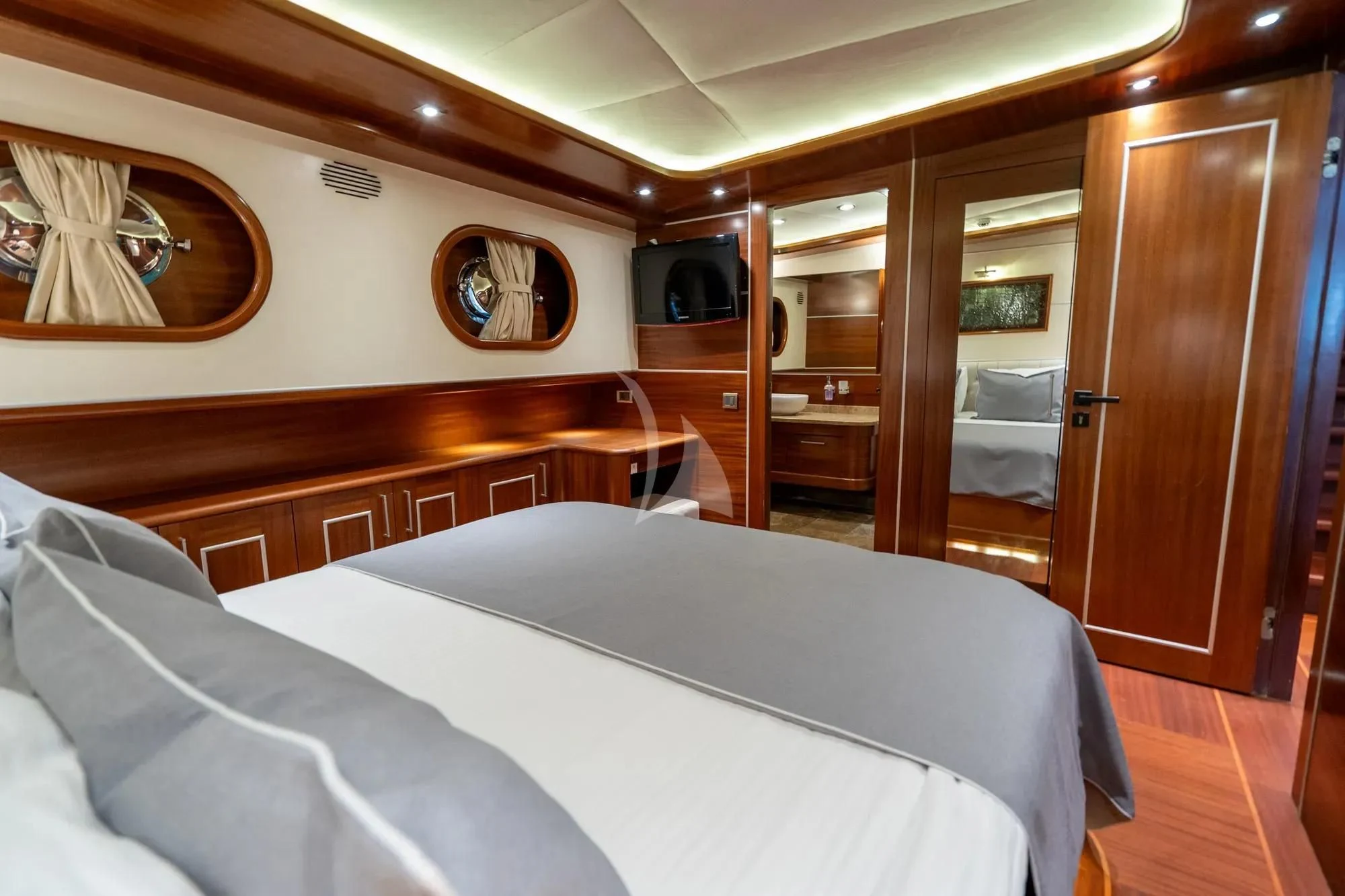 a room with a bed and a wood cabinet aboard LA BELLA VITA Yacht for Sale