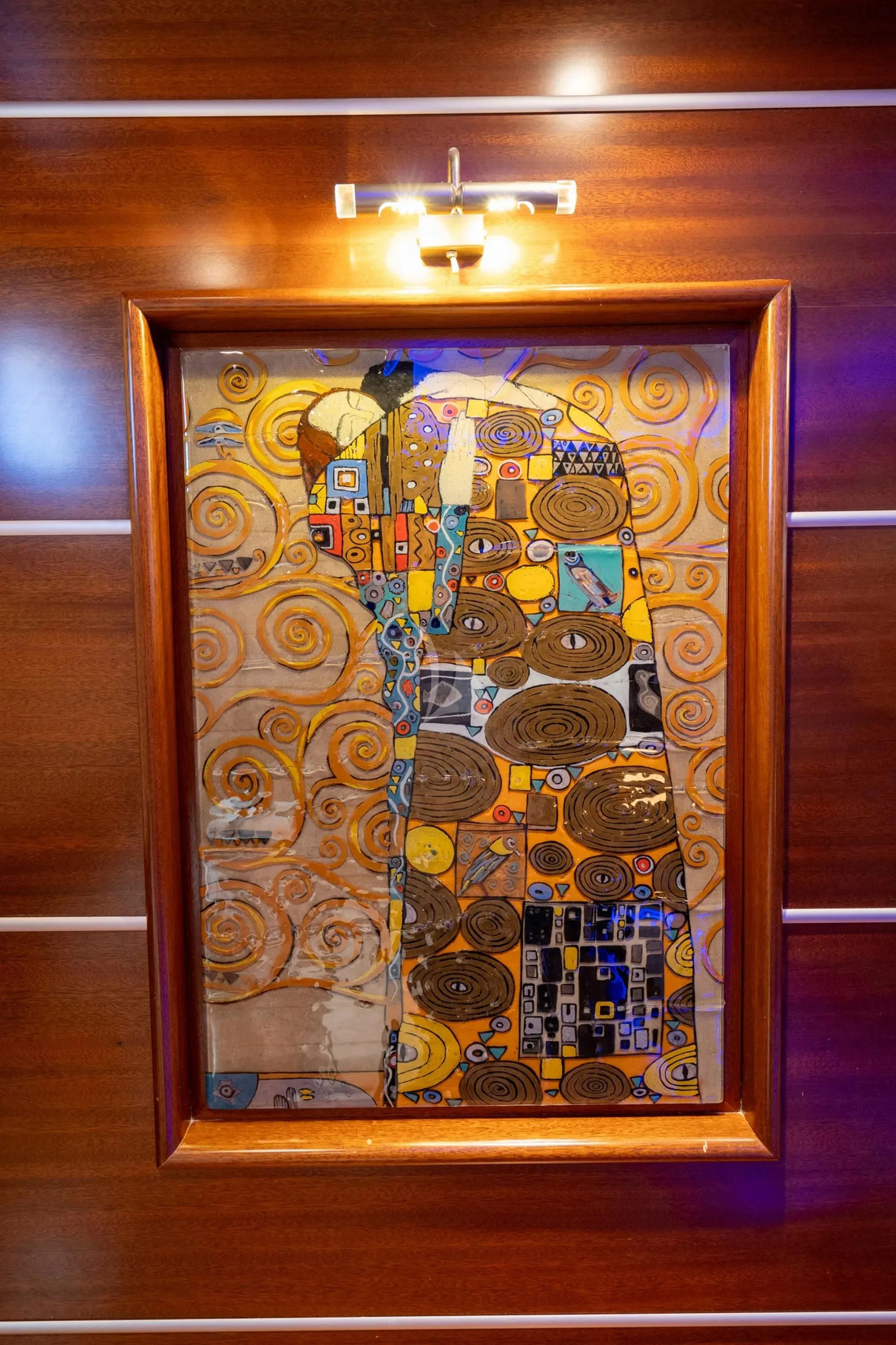 a wood cabinet with a light on it aboard LA BELLA VITA Yacht for Sale