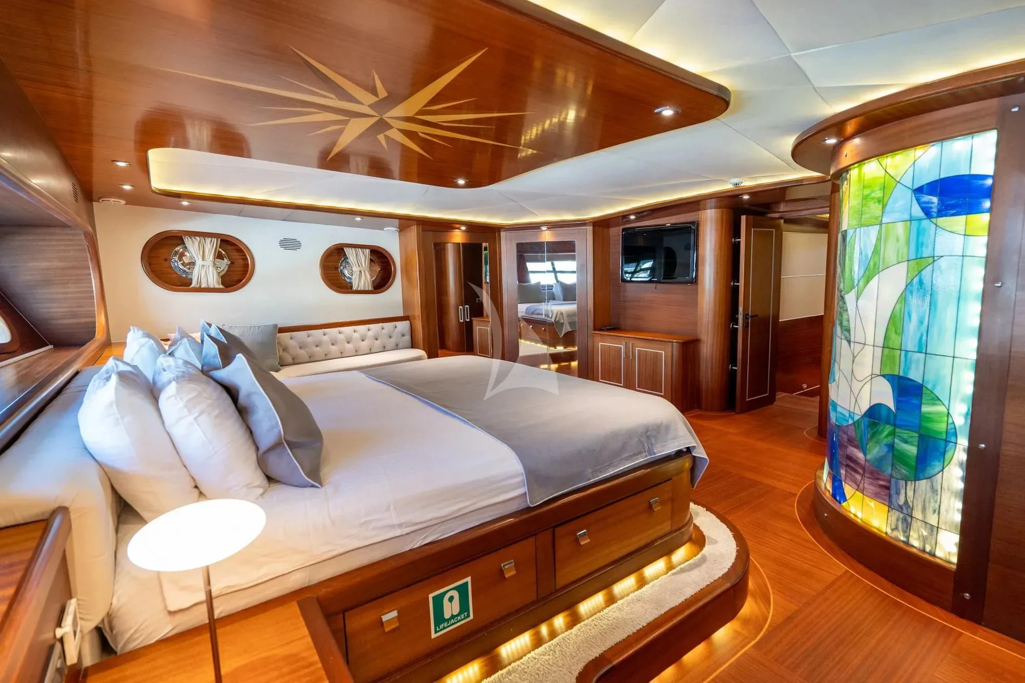 a large bedroom with a large bed aboard LA BELLA VITA Yacht for Sale