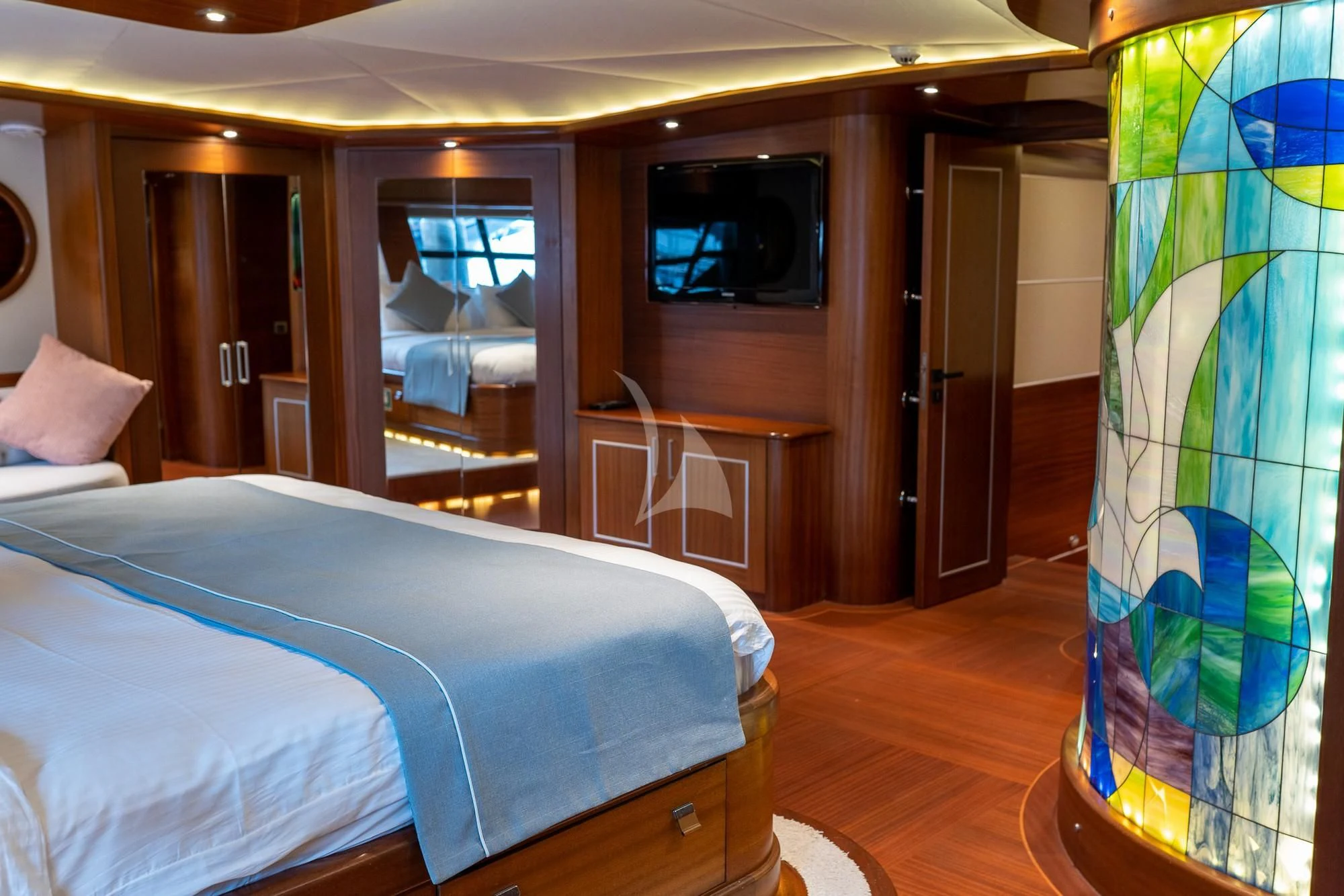 a bedroom with a bed and a television aboard LA BELLA VITA Yacht for Sale
