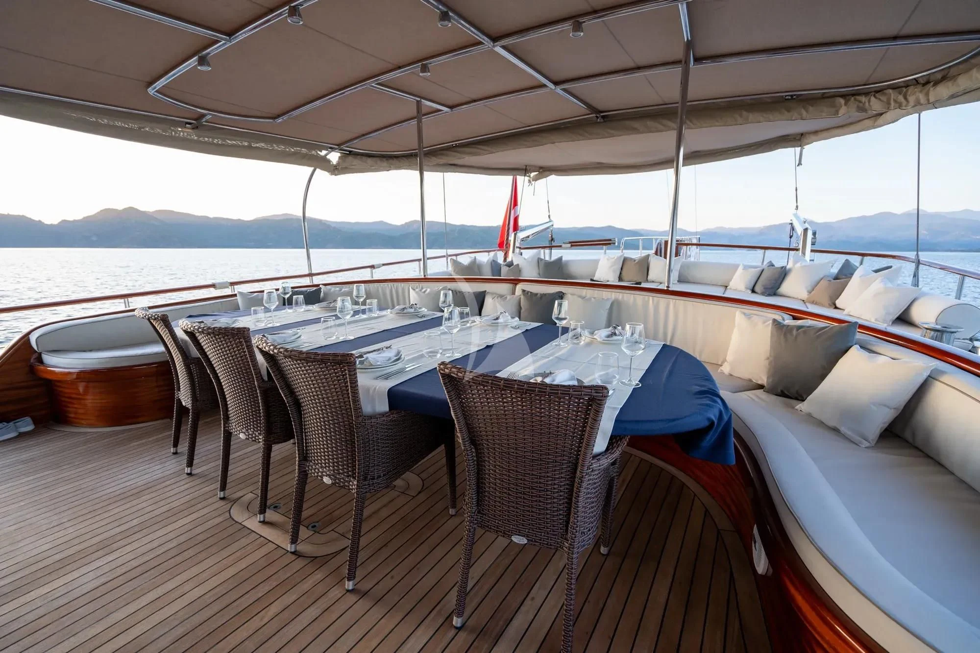 a table set for a meal on a deck aboard LA BELLA VITA Yacht for Sale