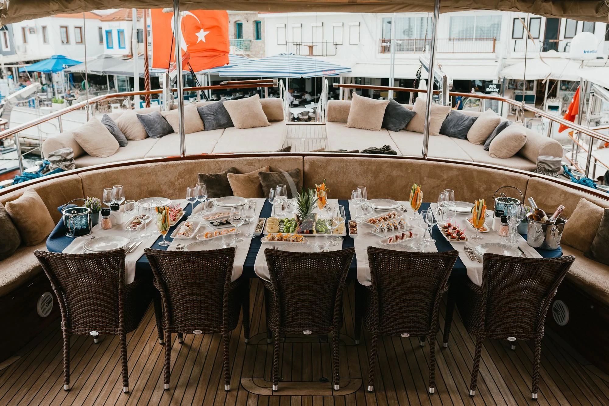 a table set with chairs and a couch aboard LA BELLA VITA Yacht for Sale