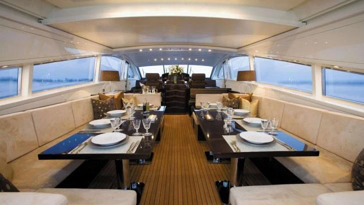 a room with tables and chairs aboard PALOMA Yacht for Sale