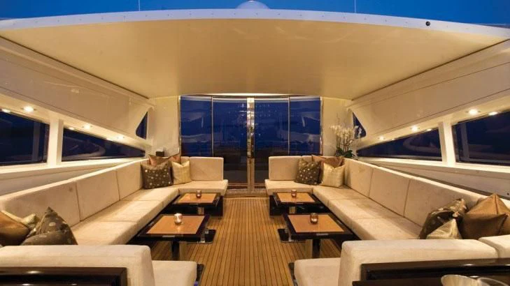 a room with a couch and a table and a large window aboard PALOMA Yacht for Sale