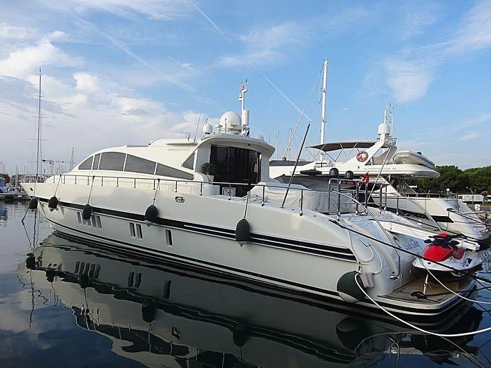 a white boat in a harbor aboard PALOMA Yacht for Sale