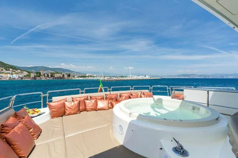 a table with a pool on a balcony overlooking a city aboard ACCAMA DELTA Yacht for Sale