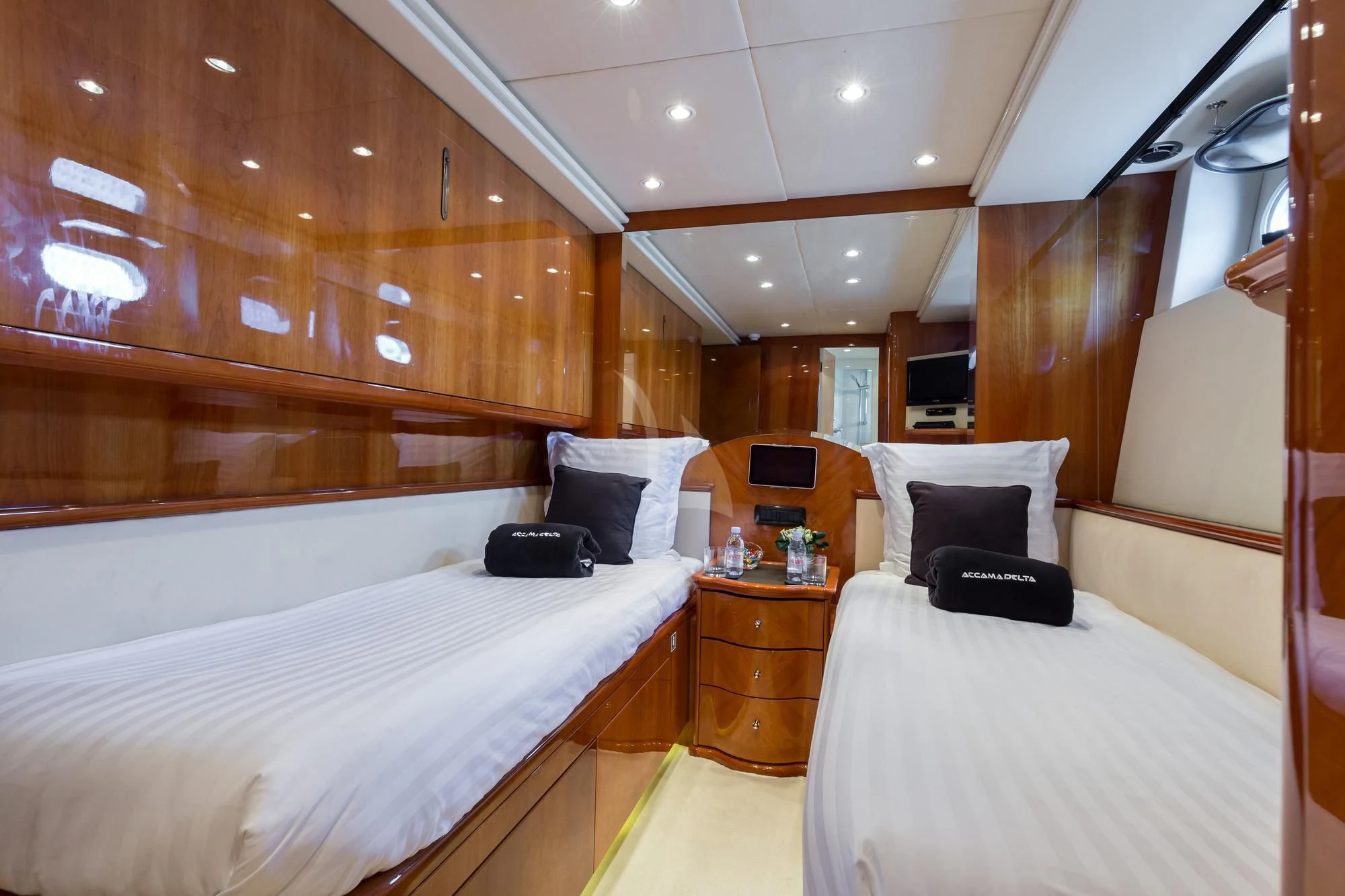 a room with a bed and a desk aboard ACCAMA DELTA Yacht for Sale