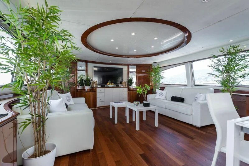 a large room with a large chandelier and a white couch aboard ACCAMA DELTA Yacht for Sale