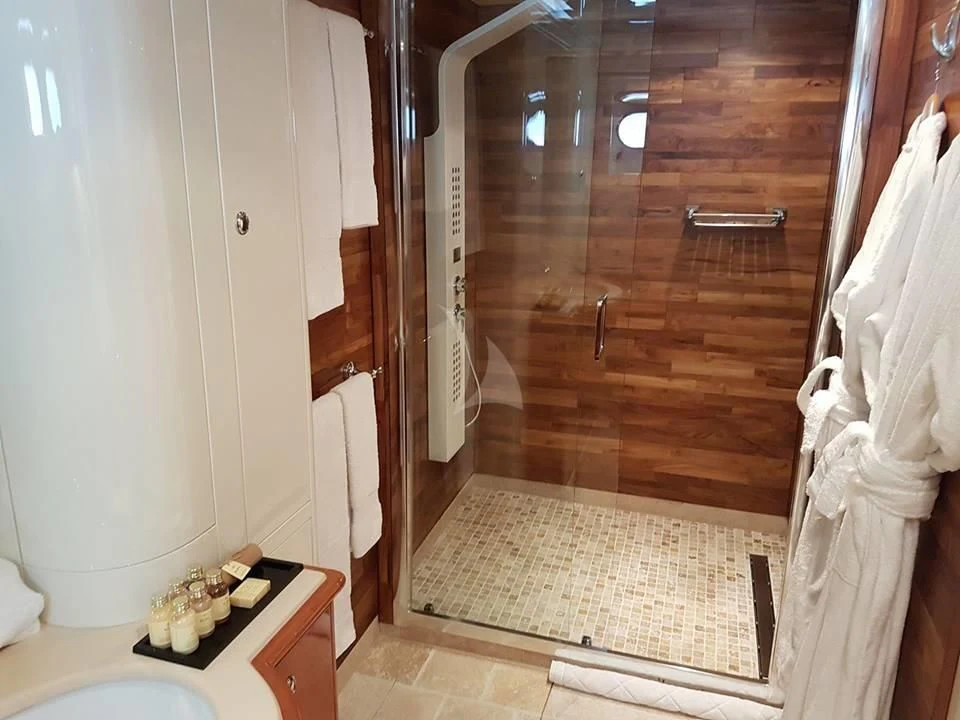 a bathroom with a wood door aboard ACCAMA DELTA Yacht for Sale