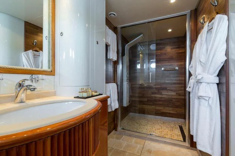 a bathroom with a sink and a mirror aboard ACCAMA DELTA Yacht for Sale
