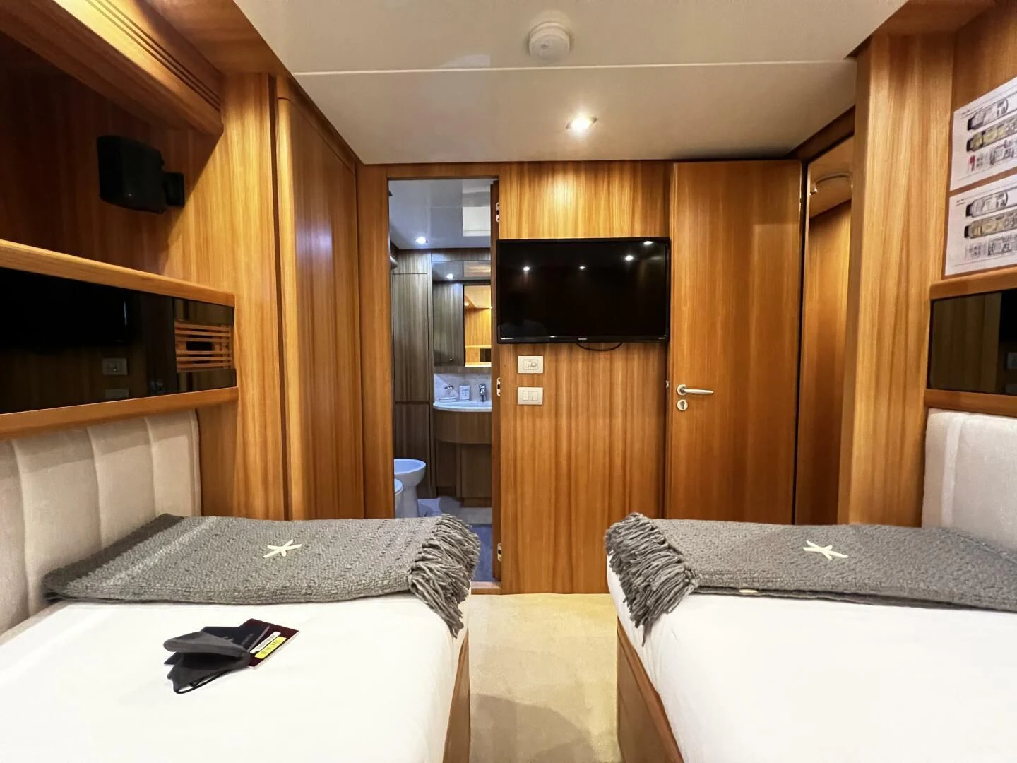 a hotel room with a bed and a television aboard KOKO Yacht for Sale