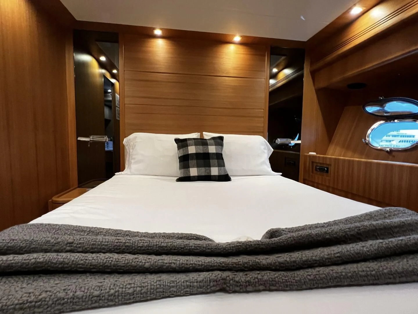 a bed with a white sheet and pillows aboard KOKO Yacht for Sale