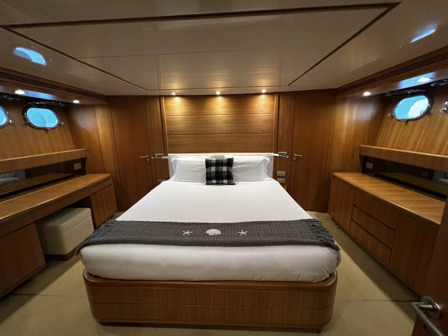 a room with a bed and desk aboard KOKO Yacht for Sale