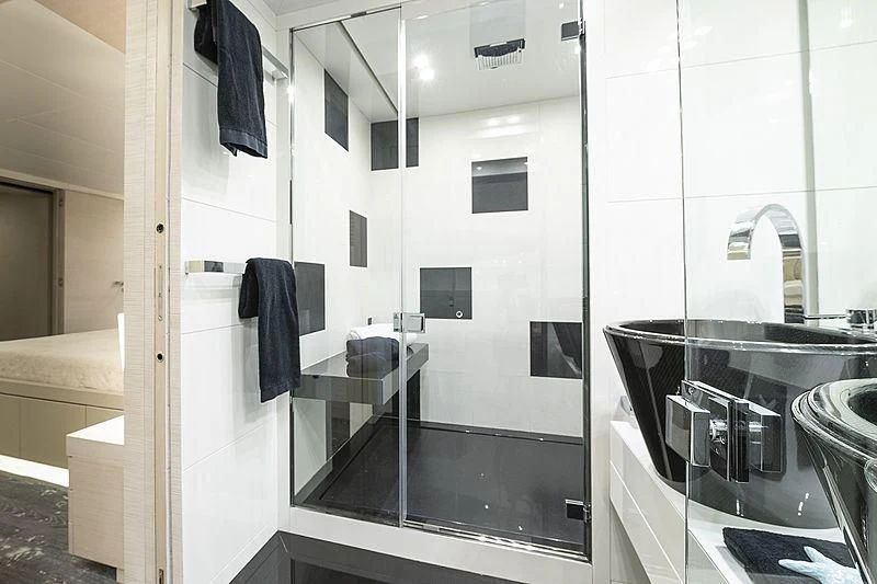 a bathroom with a glass shower aboard SEAFIRE Yacht for Sale