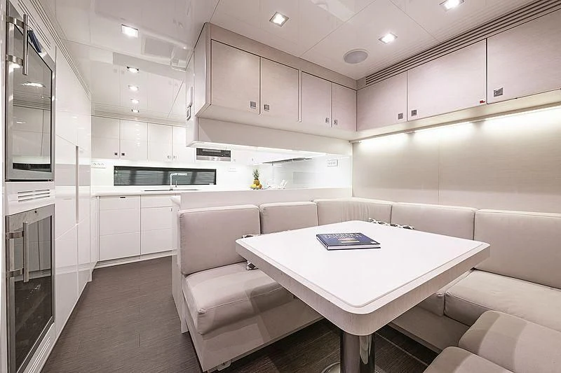 a white kitchen with a white table aboard SEAFIRE Yacht for Sale