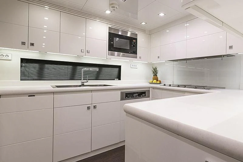 a kitchen with white cabinets aboard SEAFIRE Yacht for Sale